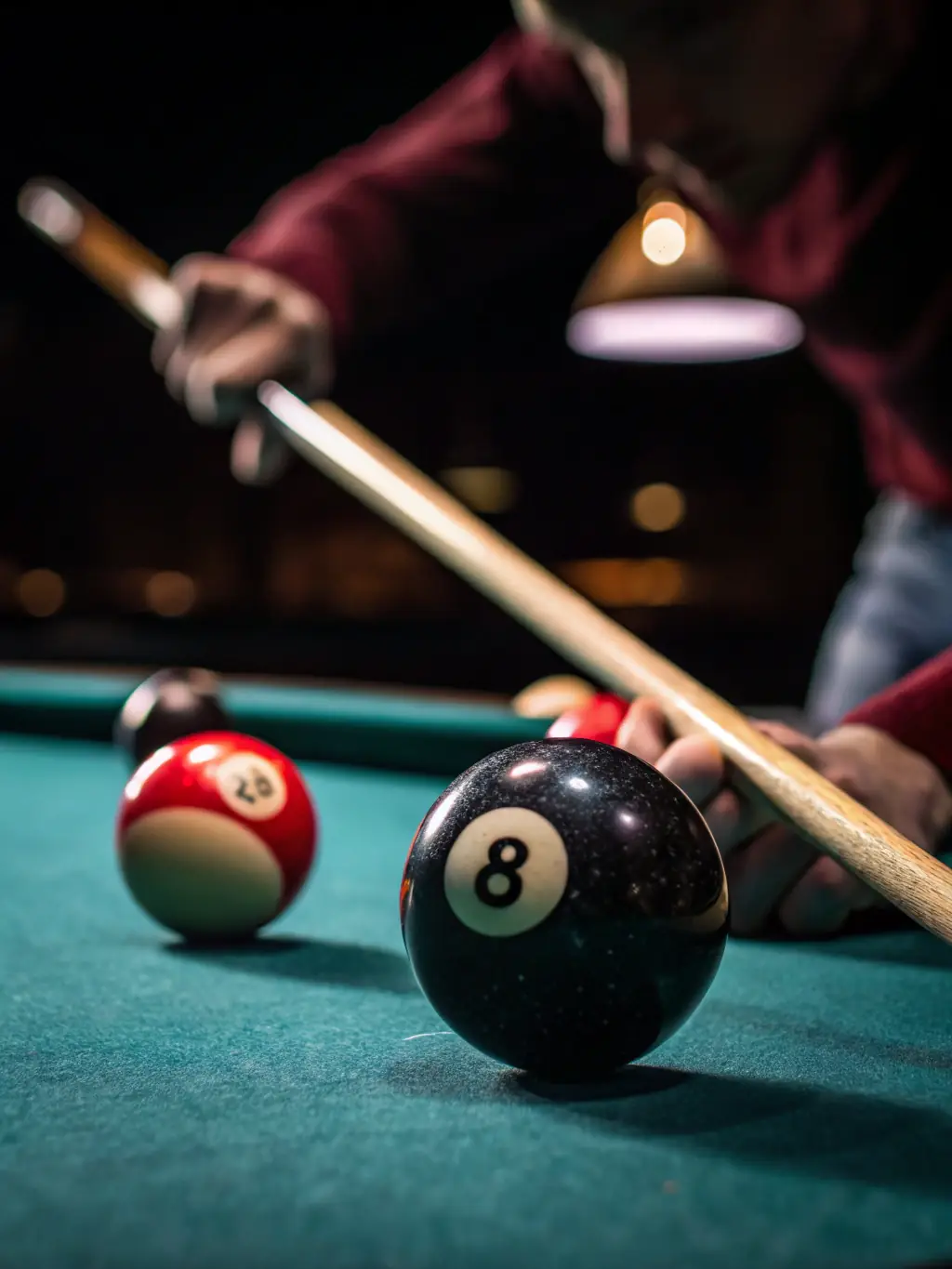 A close-up shot of a billiard ball being precisely struck by a cue stick, highlighting the focus and control required in billiards.